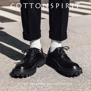 Men solid white mid tube socks paired with black leather shoes and trousers for stylish streetwear.
