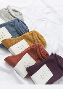 Detail shot of multi-color ruffled cuff mid-tube socks, Japanese college style cotton knit.