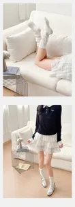 Japanese style white lace stack socks for women, cute sweet ruffle calf socks detail view.