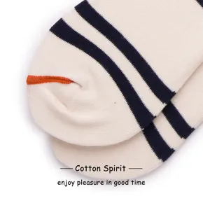 Close-up detail of cotton striped mid-tube socks, featuring classic navy and beige patterns.