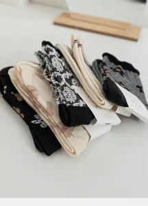 Detailed view of trendy women's vintage floral socks, cozy knit cotton blend, stylish Korean.
