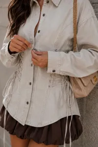 Close-up detail of casual khaki denim shirt featuring stylish waist lace-up design.