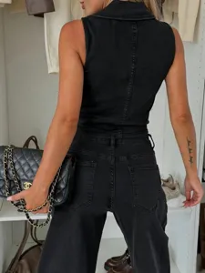 Detail view of black denim sleeveless vest and matching pants set with metal buttons.