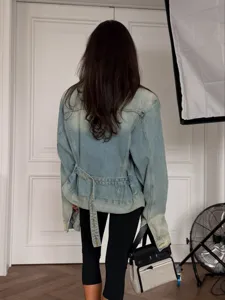 Vintage washed denim jacket for women, loose fit long sleeve lapel coat with back belt.