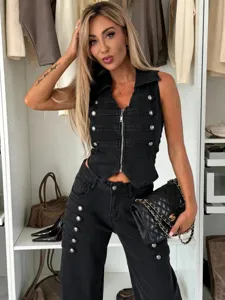 Detail shot of the stylish black denim vest and pants set featuring metal buttons and zipper.