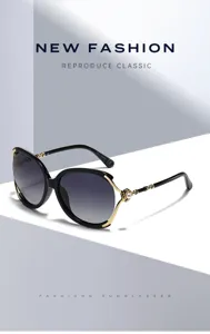 Oversized black sunglasses with gradient lenses, elegant pearl and gold metal temple details.