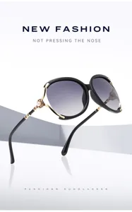 Detail view of oversized sunglasses featuring pearl decorated metal temples and gradient lenses.