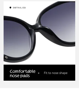 Close-up detail of oversized black sunglasses bridge and comfortable nose pads design.