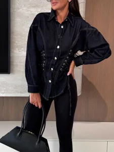 Detailed view of the stylish lace-up denim shirt with long sleeves and lapel collar for women.