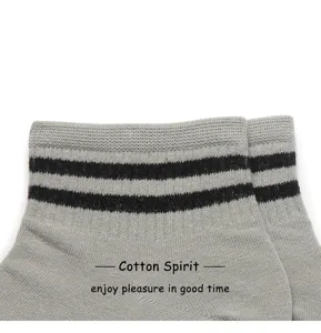 Detail view of grey cotton athletic socks with classic black double stripes, comfortable sport wear.