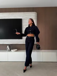Detailed view of women denim set, dark wash cropped jacket and wide leg pants scene.