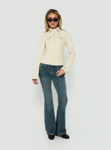 Detailed view of the women's slim fit zip up utility jacket paired with flared denim jeans.