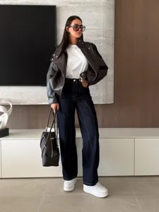 Detailed view of women's contrast stitching denim wide leg pants and jacket outfit set.