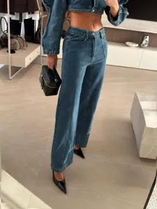 Stylish denim two-piece set featuring a cropped puff sleeve jacket and wide leg pants.