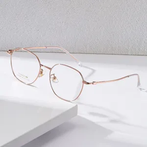 Montatura per occhiali tonda sottile in beta titanio oro rosa, stile retro classico vista principale.