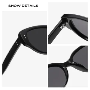 Lunettes de soleil cat-eye rétro noires avec détails de charnière en métal et design.