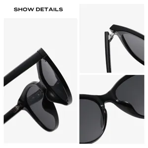 Lunettes de soleil noires élégantes pour femme, voyage en plein air et mode tendance, détails clairs.