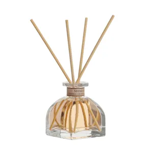 Glass bottle reed diffuser set with wooden sticks and scented oil for home fragrance.