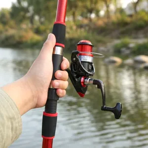 Fishing rod and reel combo set detail view, featuring red spinning reel and comfortable grip pole.