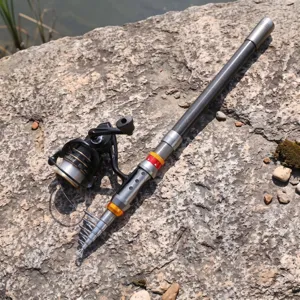 Close-up detail of carbon fiber telescopic fishing rod and spinning reel outdoors.