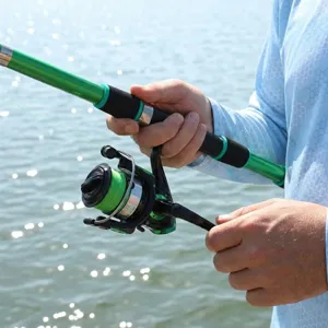 Detailed view of green telescopic fishing rod and spinning reel set for outdoor angling.
