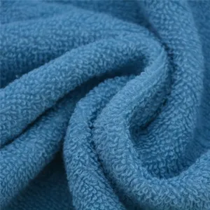Detailed view of soft blue cotton towel fabric, thick loops for high water absorption.