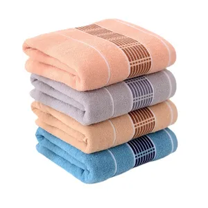 Soft cotton bath towels stack in four colors, absorbent and thick for daily home use.