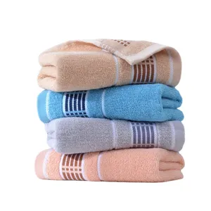 Stack of four soft pure cotton bath towels in assorted solid colors with stylish plaid patterns.