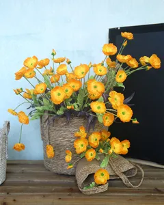 Detailed view of artificial orange poppy flowers with flocked stems and rustic woven basket decor.