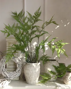 Artificial fern leaf floral arrangement detail shot, realistic green foliage decor for home