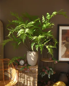 Detailed view of artificial golden silk fern leaf green plant floral accessory for home decor.
