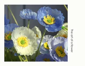 Detailed close-up of artificial blue and white poppy flowers featuring soft textured petals.