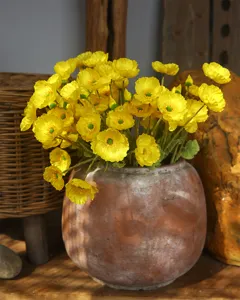 Detailed view of artificial yellow poppy bouquet, flocked silk flowers in rustic pot for home decor.