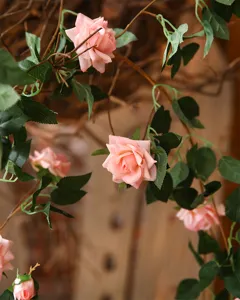Artificial pink rose flower vine detail shot, realistic floral decoration for wall decor.