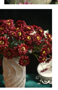 Detailed view of vintage artificial burgundy sunflower bouquet, elegant floral decor for home.