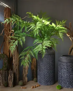 Detailed view of artificial fern leaf foliage for floral arrangement and landscape display.