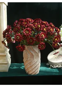 Vintage artificial sunflower bouquet in retro vase for elegant home dining table decor.