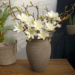 Artificial white magnolia flower bouquet in rustic ceramic vase for home decor living room