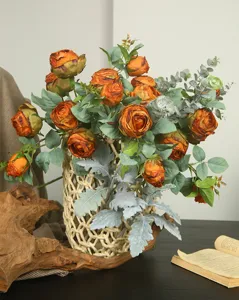Detail view of artificial burnt-edge rose bouquet with eucalyptus leaves for home decor.