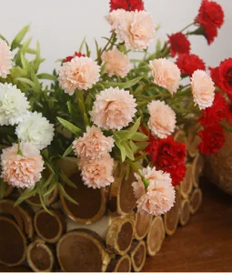 Artificial carnation flower arrangement with wooden pot for home living room decor.