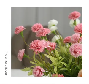 Close-up detail of artificial pink and white carnation flowers for home floral decor.