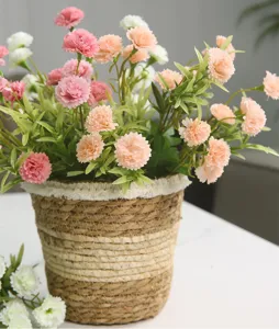 Artificial carnation flower arrangement in woven basket for home living room dining table decor.