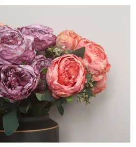 Detailed close-up of artificial peony flower bouquet in a black vase for home decor.