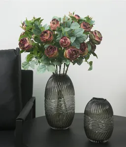 Artificial rose flowers bouquet with ribbed glass vases for living room home decor setup.
