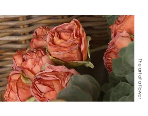 Vintage artificial burnt-edge rose bouquet detail shot, perfect for home table decor.