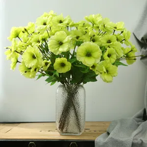 Artificial green ranunculus flowers bouquet in glass vase for home dining table decor