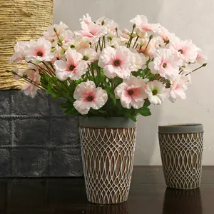 Artificial pink ranunculus flowers in decorative pot for home living room table decor