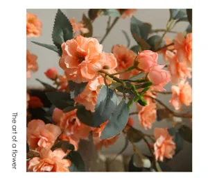 Orange artificial camellia flower branch detail close up for home indoor decor display.