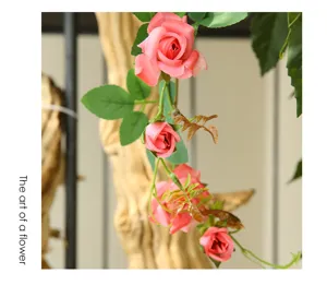 Artificial rose vine detail shot, pink silk flowers for wedding and home ceiling decor.