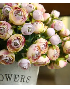 Artificial flower detail showing pink camellia arrangement in vintage pot for home decor close up